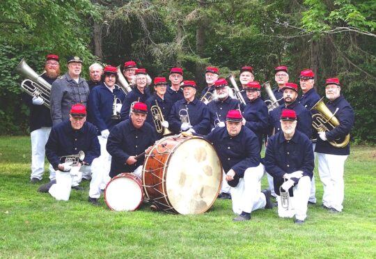 All the members of the 2022 Yankee Brass Band arranged in 3 rows by instrument.